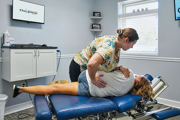 Chiropractor Albion MI Samantha Sweeney Adjusting Patient Lower Back