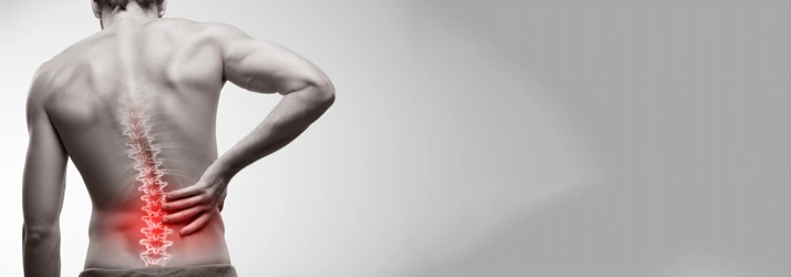 Chiropractic Jackson MI Man With Red Back Pain A man with lower back pain.
